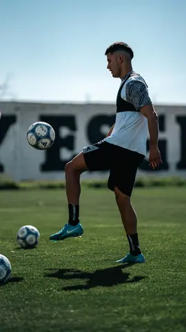 Young athlete demonstrating soccer skills on the field during daylight practice.