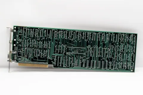 Close-up of a vintage circuit board showcasing intricate soldered connections.