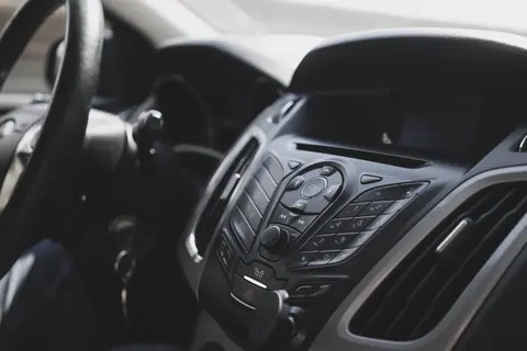 Close-up view of a modern car interior focusing on the dashboard and steering wheel.