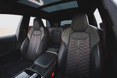 High-end automotive interior showcasing leather seats and panoramic sunroof for ultimate comfort and style.
