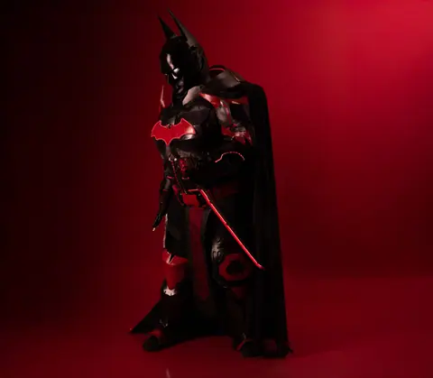 Intense red and black cosplay character on a dramatic red background.