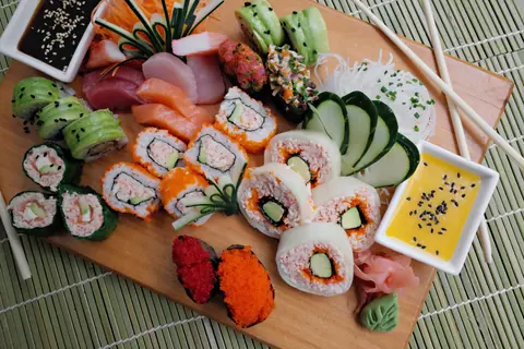 A vibrant sushi platter with various rolls and sashimi, perfect for food lovers.