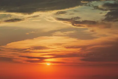 Breathtaking sunset over Santa Maria di Castellabate with vivid orange and red hues in the sky.