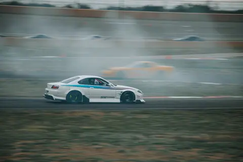 A thrilling car drift captured during a race in Colorado Springs, showcasing speed and skill.