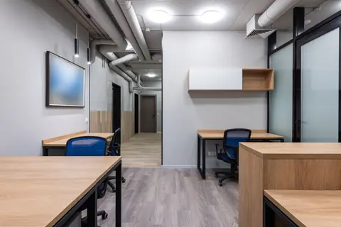 Contemporary office interior with minimalist design and wooden furniture.