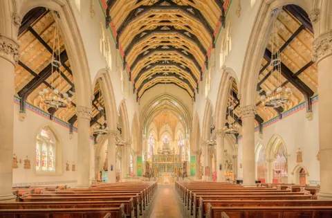 Breathtaking view of Lancaster Cathedral's gothic interior showcasing its architectural beauty.