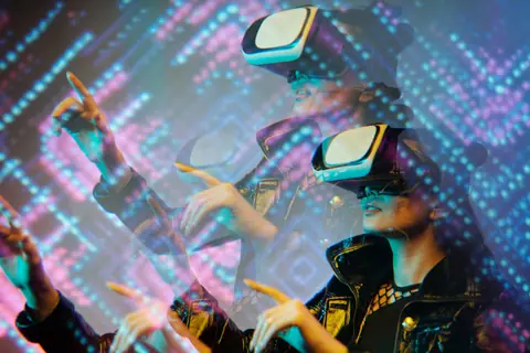 Woman enjoying a virtual reality simulation with futuristic graphics in a dimly lit room.