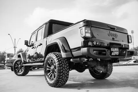 Monochrome image of a rugged off-road jeep truck with large tires.
