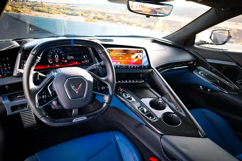 High-end sports car interior showcasing sleek design and advanced digital dashboard features.
