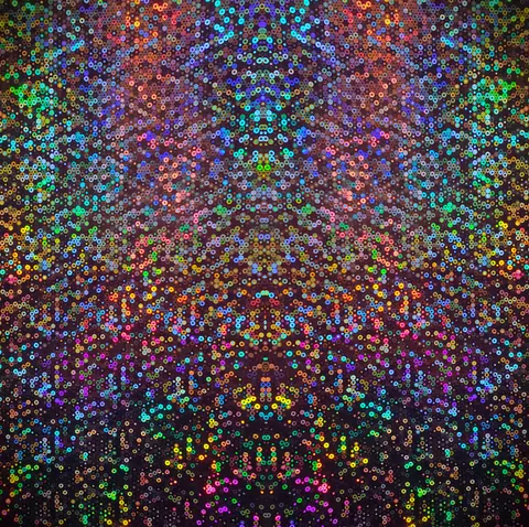 Colorful sequin pattern with rainbow hues creates a mesmerizing abstract backdrop.