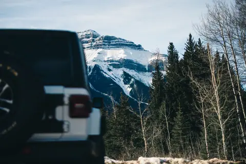 Snow-covered mountain with Jeep in Jasper National Park, Alberta, Canada.