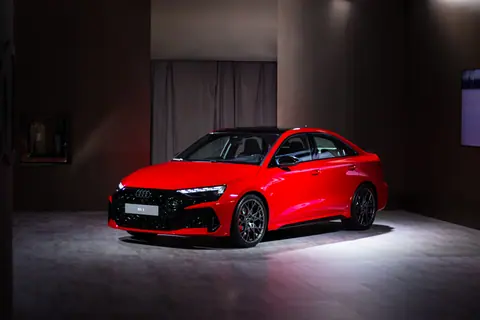 Red Audi RS on display in a Toronto studio with dramatic lighting.