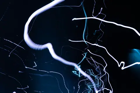 Captivating abstract image featuring vibrant light trails on a dark background.