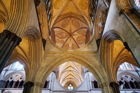 Explore the ornate gothic ceiling and arches of Salisbury Cathedral's interior.