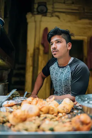 Street vendor in Varanasi selling traditional Indian snacks.