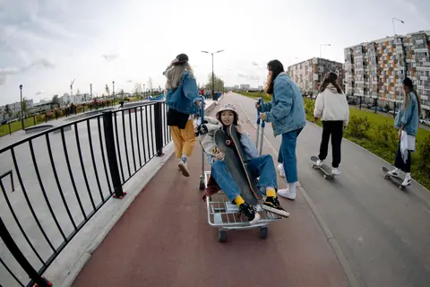 Group of young women skateboarding and having fun outdoors, enjoying a sunny day.