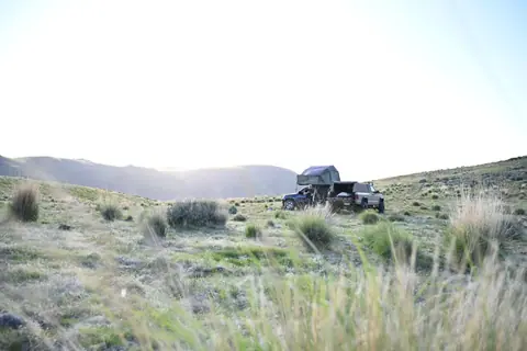 4x4 vehicle camping in remote grassland, perfect for adventure and exploration.
