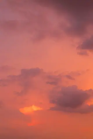 Beautiful dramatic sunset sky with pink and orange clouds creating a serene atmosphere.