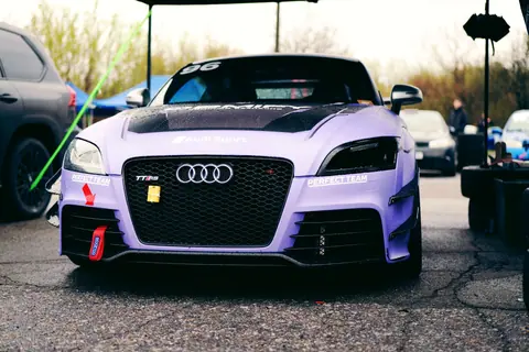 Close-up of a purple Audi TT RS at a racing event outdoors in Ukraine.