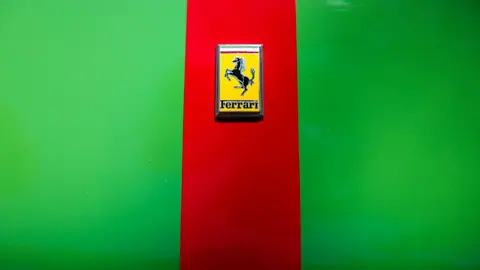 Ferrari logo on a red and green background, emphasizing the brand's iconic design.